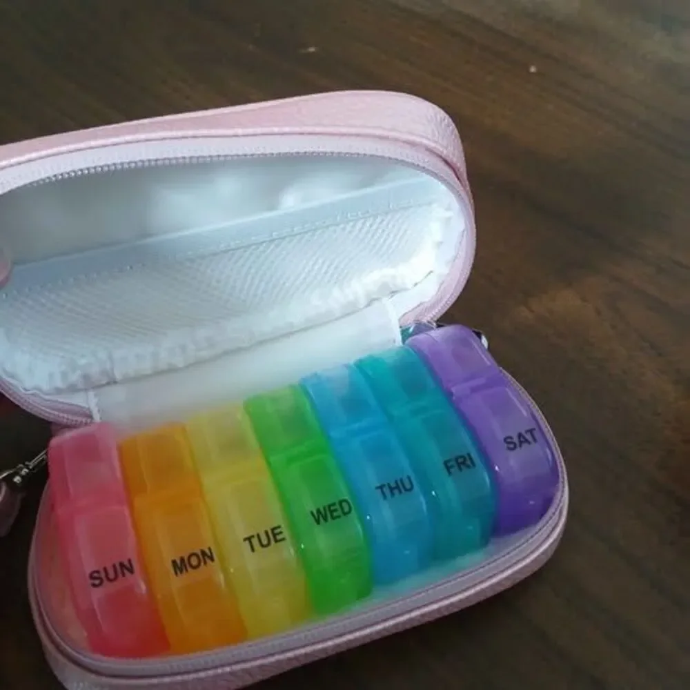 7-day pill organizer designed for use twice daily, w/ pink leather bag